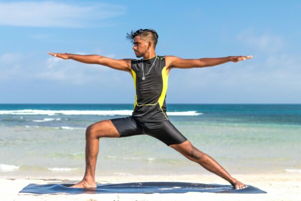 man-doing-yoga-at-the-beach