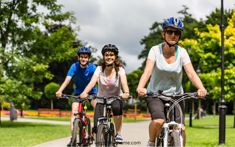 benefits-of-biking-everyday - a family on their bikes in a park